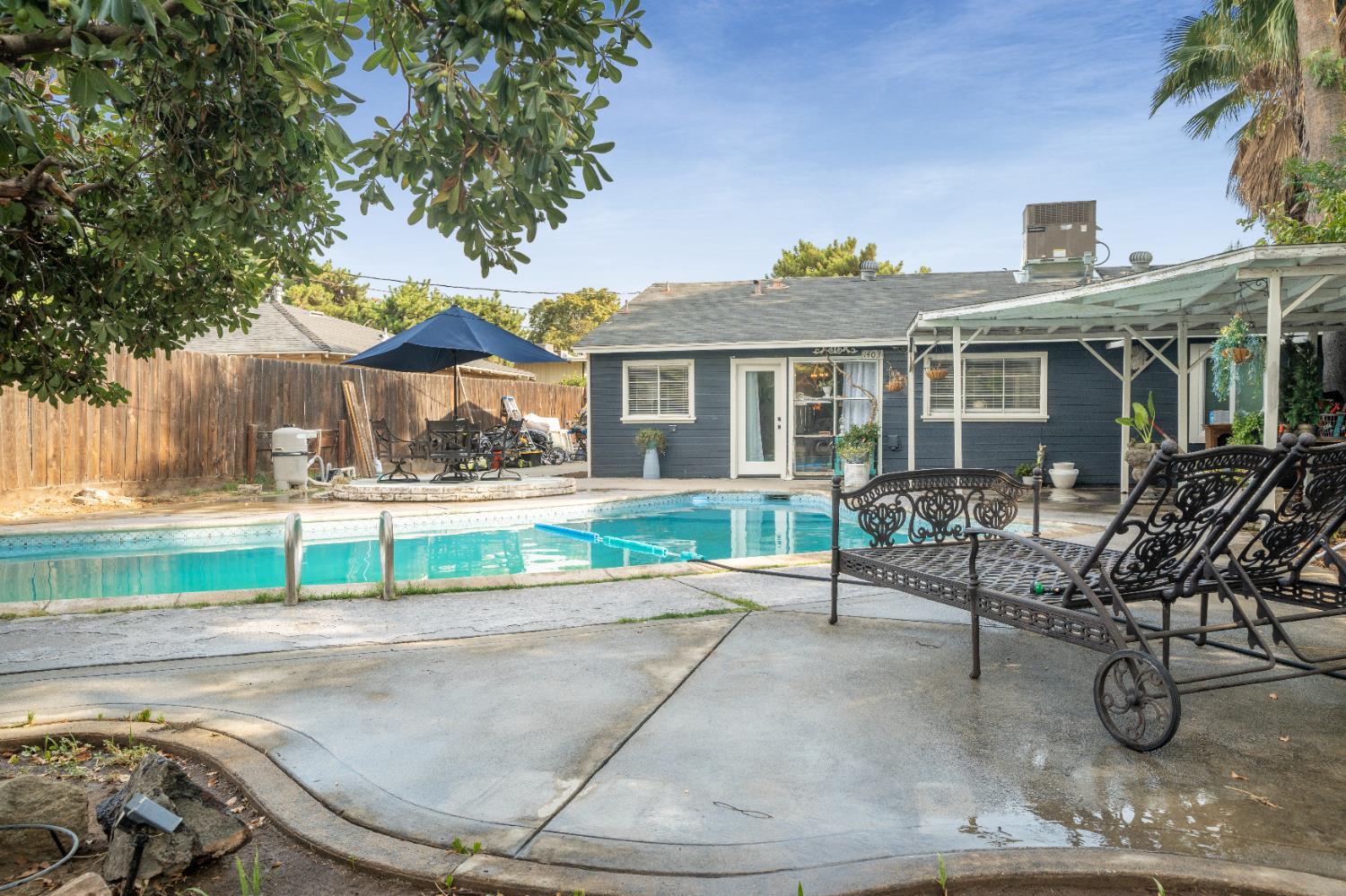1403 East Griffith Way Fresno, CA 93704 - Photo 6 of 27 a view of a house with a patio