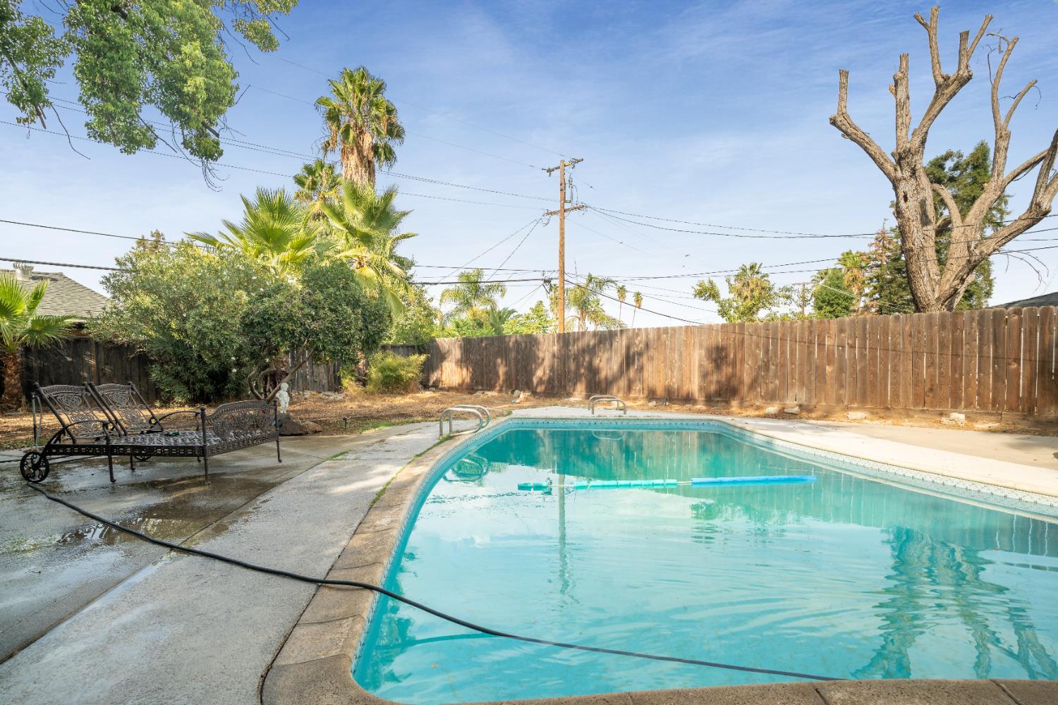 1403 East Griffith Way Fresno, CA 93704 - Photo 10 of 27 a backyard of a house with table and chairs