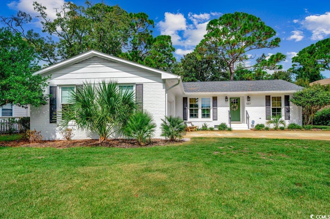 Ranch-style home featuring brick siding and a front lawn