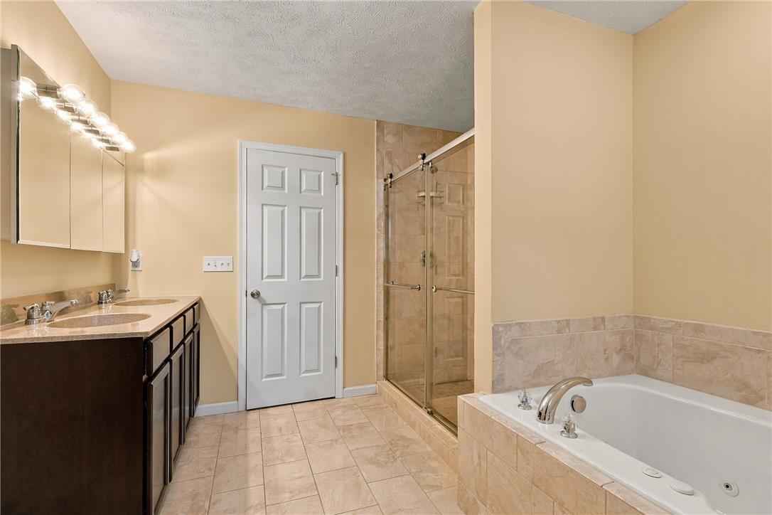 1657 Rachel Road Stroudsburg, PA 18360 - Photo 30 of 46 Tiled flooring runs throughout this bathroom complete with a double vanity and soaking tub.