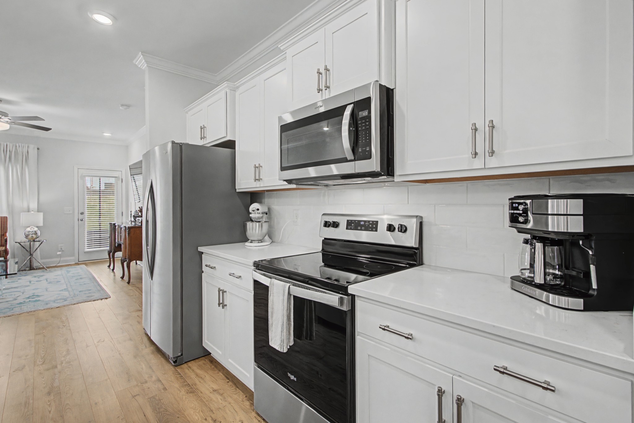 1066 June Wilde Ridge Spring Hill, TN 37174 - Photo 7 of 33 a kitchen with stainless steel appliances a stove microwave and a refrigerator