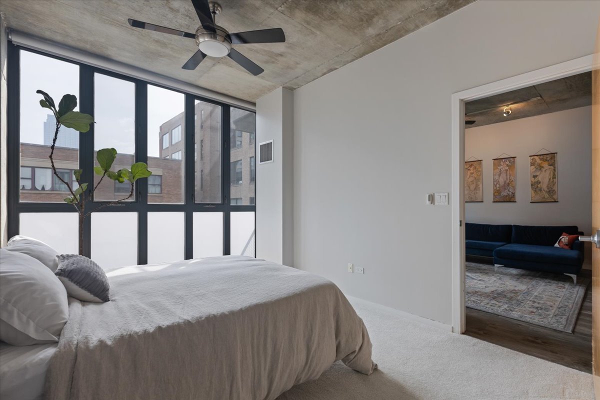 321 South Sangamon Street, Unit 508 Chicago, IL 60607 - Photo 19 of 29 a bedroom with a bed and glass walk in closet