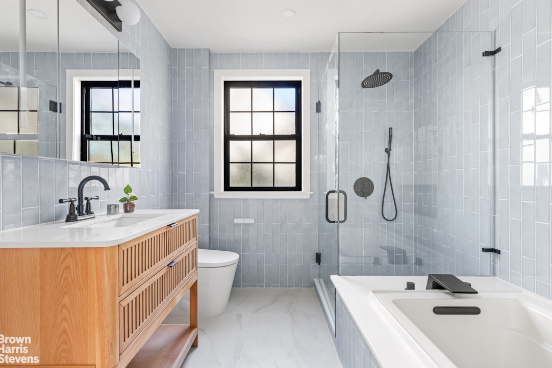 85-03 Wareham Place Queens, NY 11432 - Photo 12 of 21 a bathroom with a sink a toilet a mirror and shower