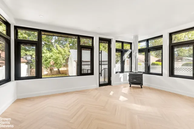 a spacious bedroom with a bed and a large window