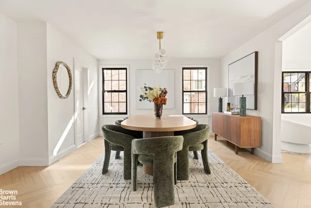 a view of a a dining room with furniture window and wooden floor