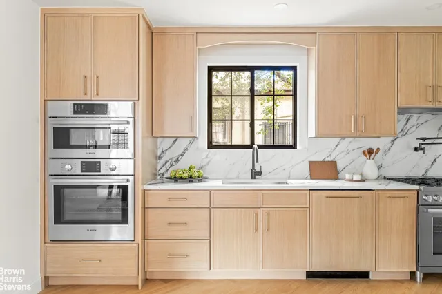 a kitchen with stainless steel appliances granite countertop a sink and a microwave