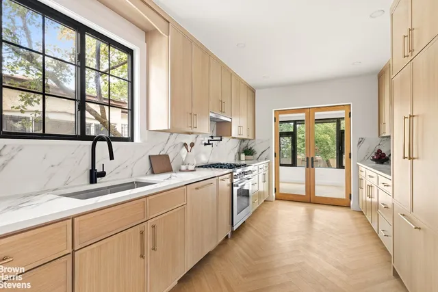 a large white kitchen with a large window