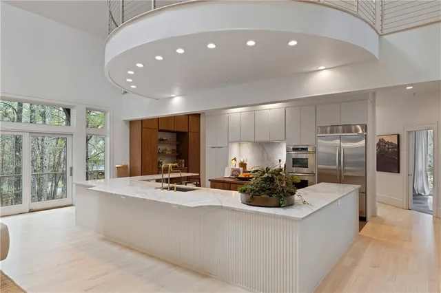 a kitchen with granite countertop a stove and a white cabinets