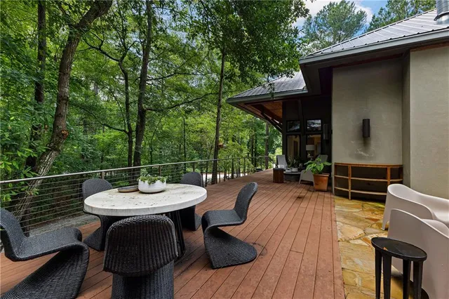 a spacious bedroom with a bed and a flat screen tv