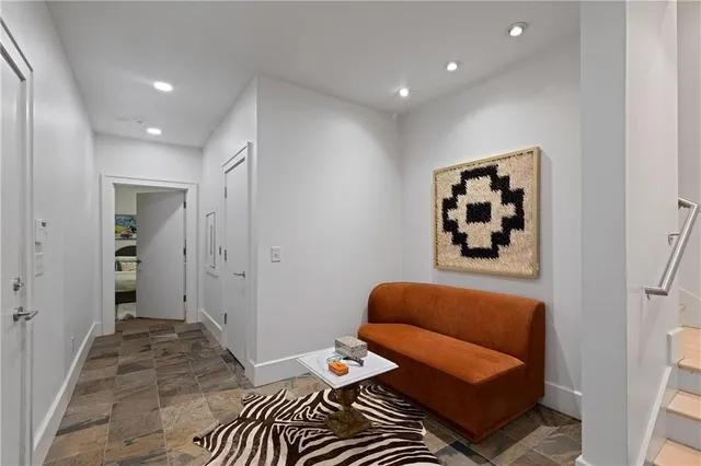 a hallway with sink and mirror