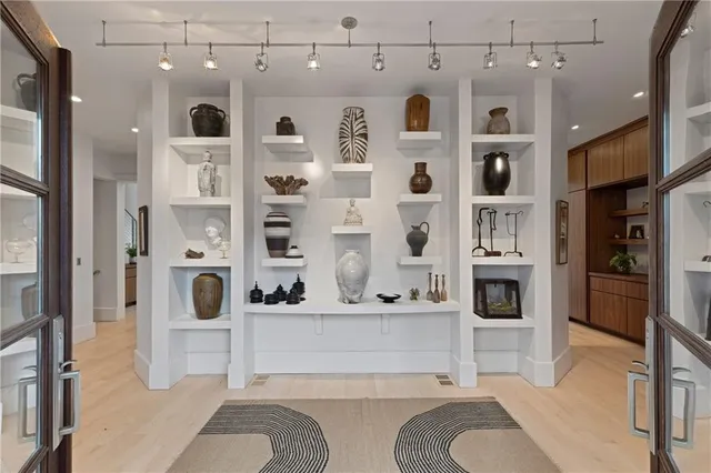 a spacious bedroom with a large bed and a large window