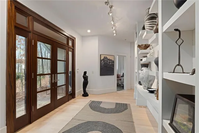 a living room with furniture a chandelier and a window
