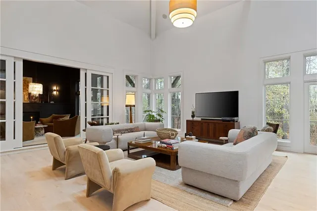 a living room with furniture fireplace and a large window