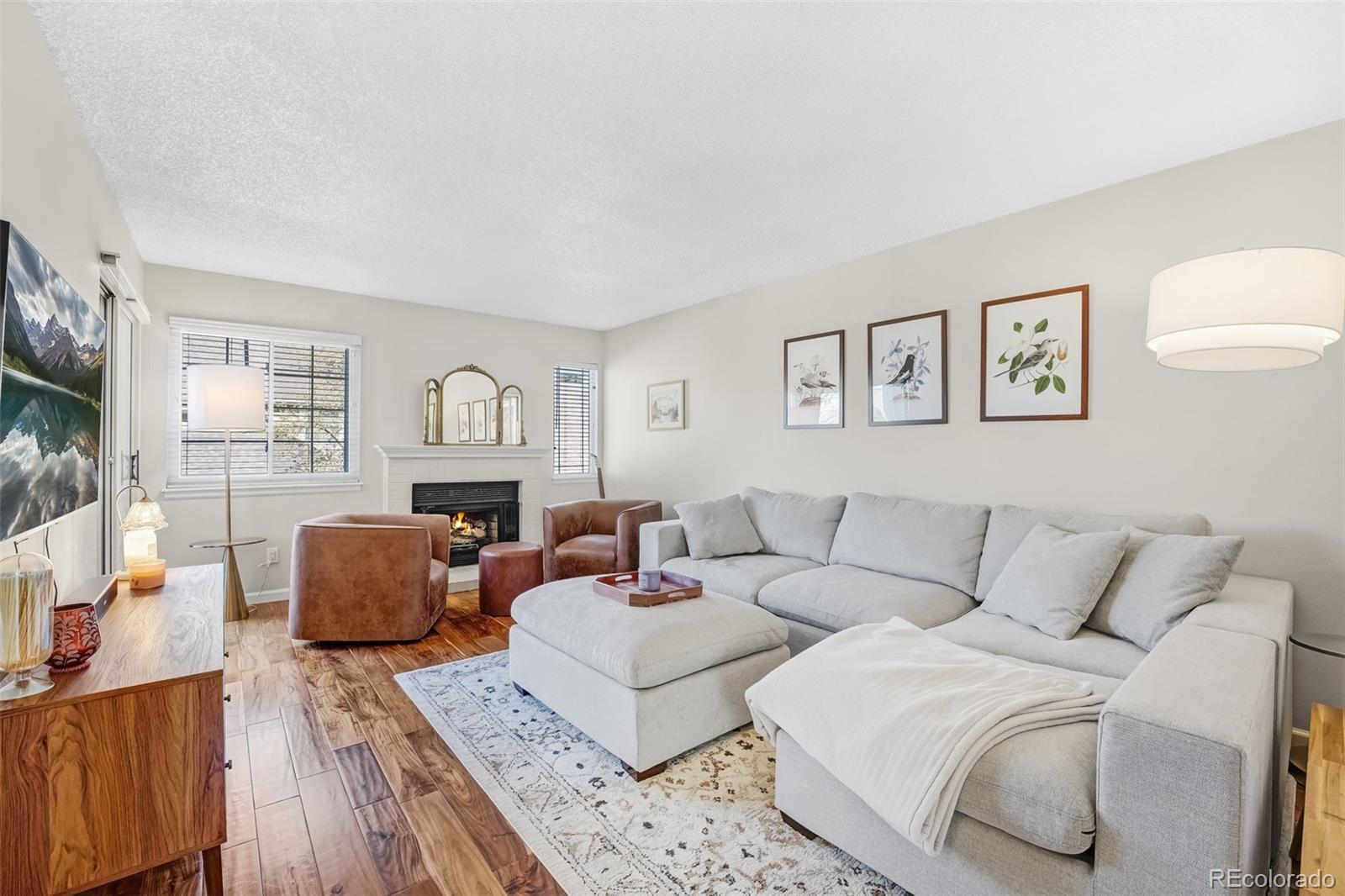 1470 South Quebec Way, Unit 282 Denver, CO 80231 - Photo 1 of 38 a living room with furniture and a flat screen tv
