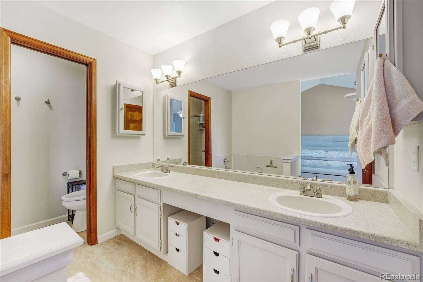 1470 South Quebec Way, Unit 282 Denver, CO 80231 - Photo 16 of 38 a bathroom with a sink double vanity and a mirror