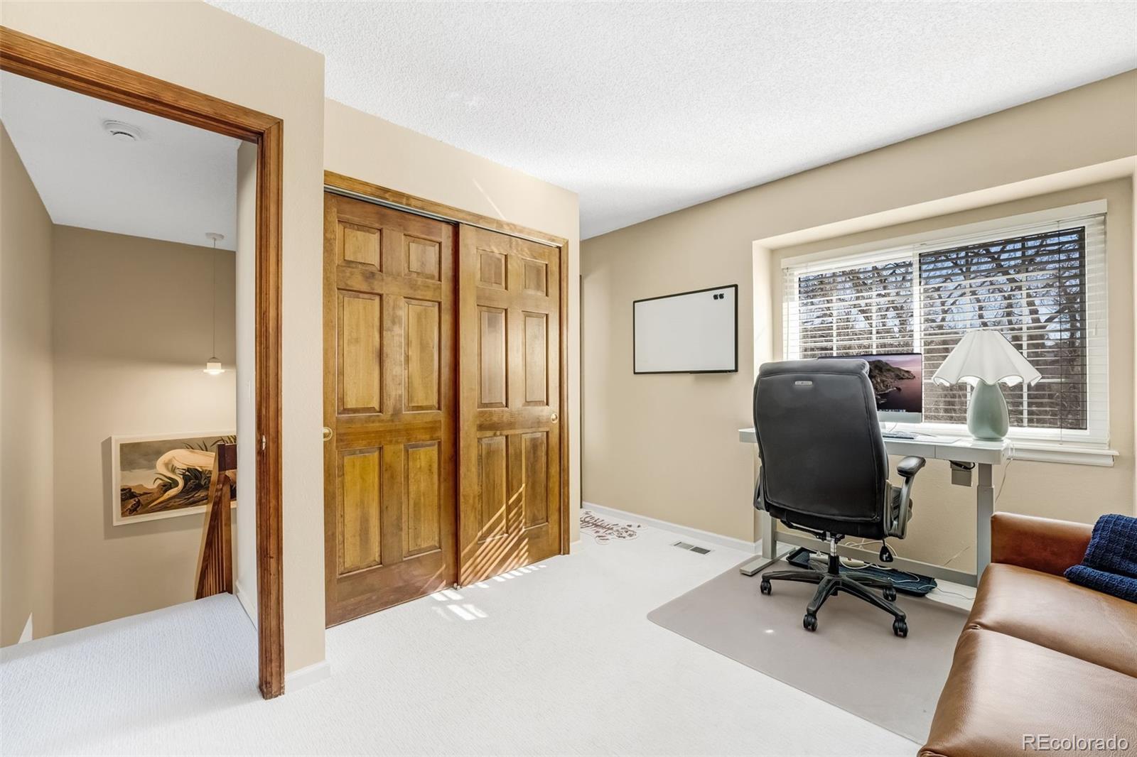 1470 South Quebec Way, Unit 282 Denver, CO 80231 - Photo 19 of 38 a view of a livingroom with workspace and a window