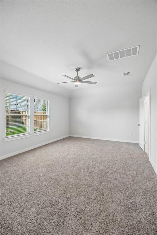 1448 Companero Street Haslet, TX 76052 - Photo 20 of 35 a view of an empty room with windows