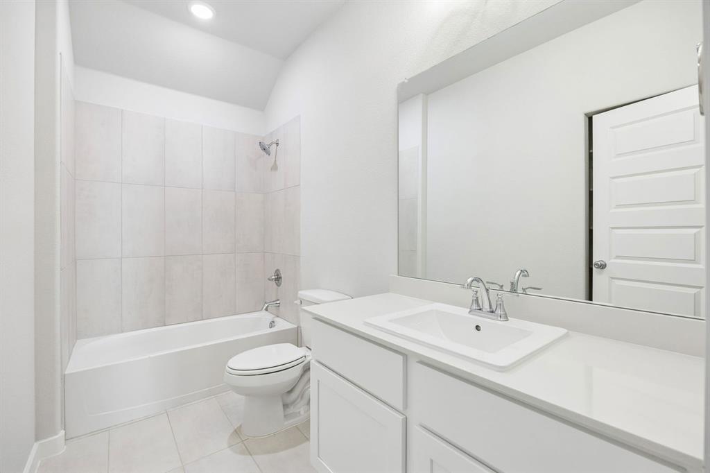 1448 Companero Street Haslet, TX 76052 - Photo 28 of 35 a bathroom with a sink a toilet and shower