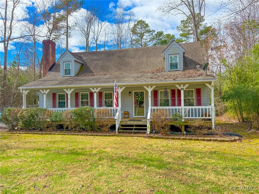 a front view of a house with a yard and trees