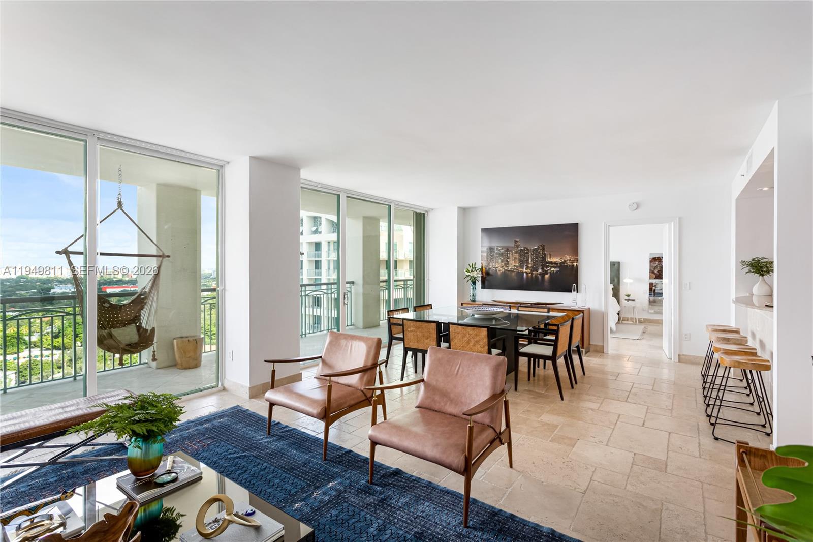 3400 Southwest 27th Avenue, Unit 2104 Miami, FL 33133 - Photo 12 of 26 a living room with furniture and a floor to ceiling window