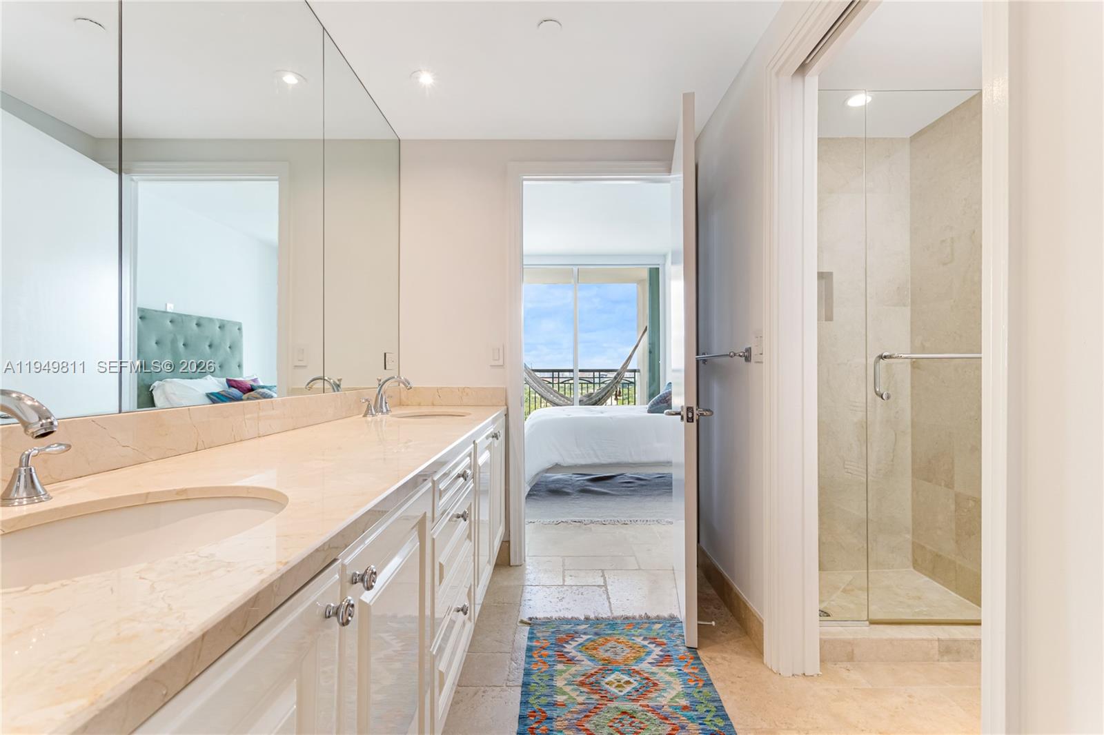 3400 Southwest 27th Avenue, Unit 2104 Miami, FL 33133 - Photo 19 of 26 a bathroom with a sink a mirror and a shower