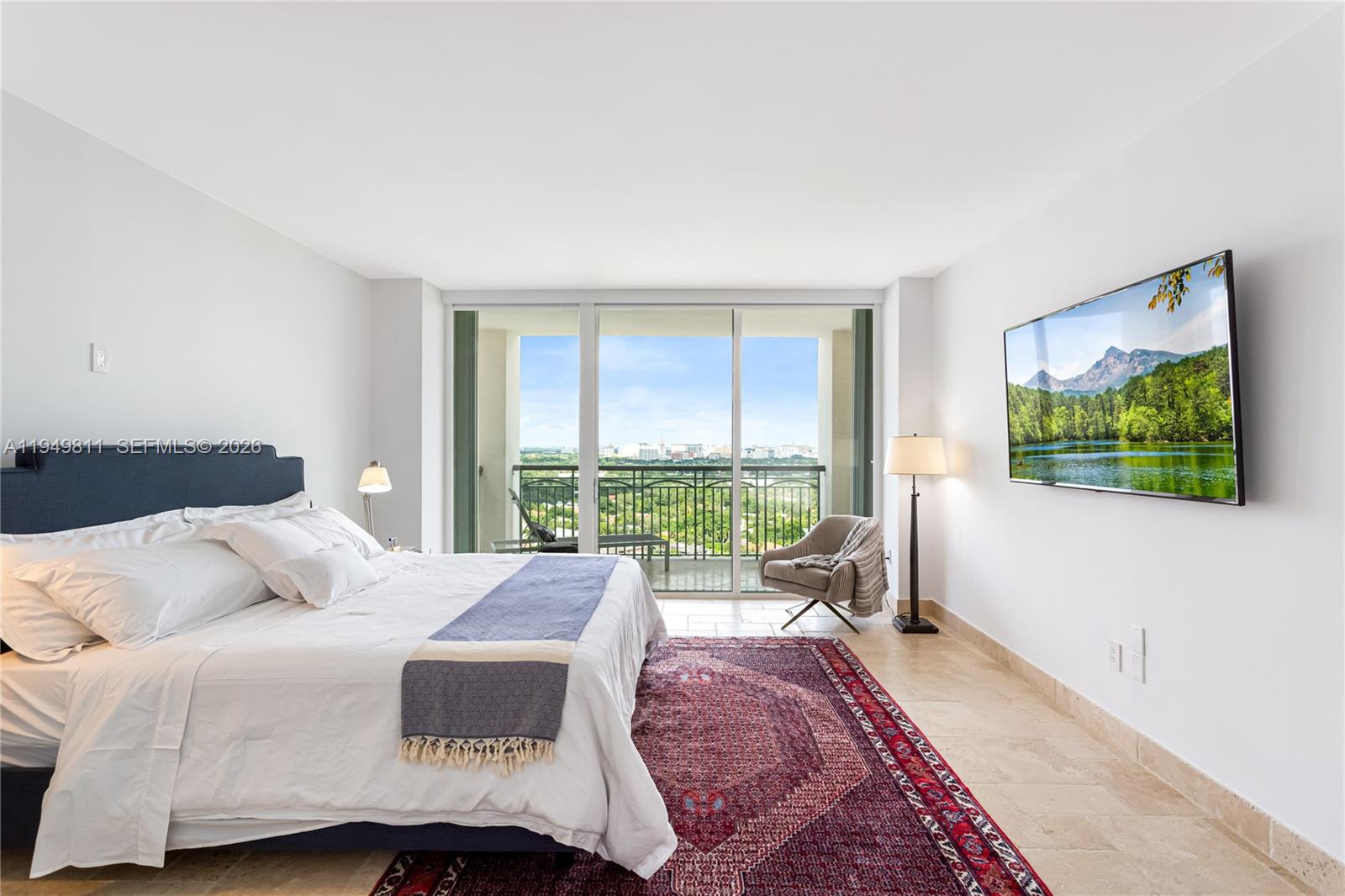 3400 Southwest 27th Avenue, Unit 2104 Miami, FL 33133 - Photo 24 of 26 a bedroom with a bed and glass windows