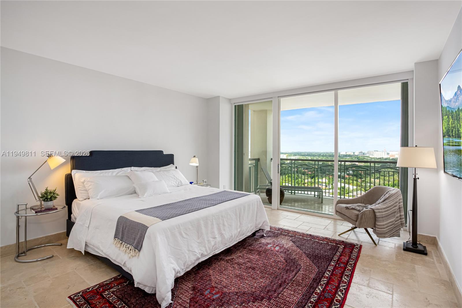 3400 Southwest 27th Avenue, Unit 2104 Miami, FL 33133 - Photo 25 of 26 a bedroom with a bed and glass window