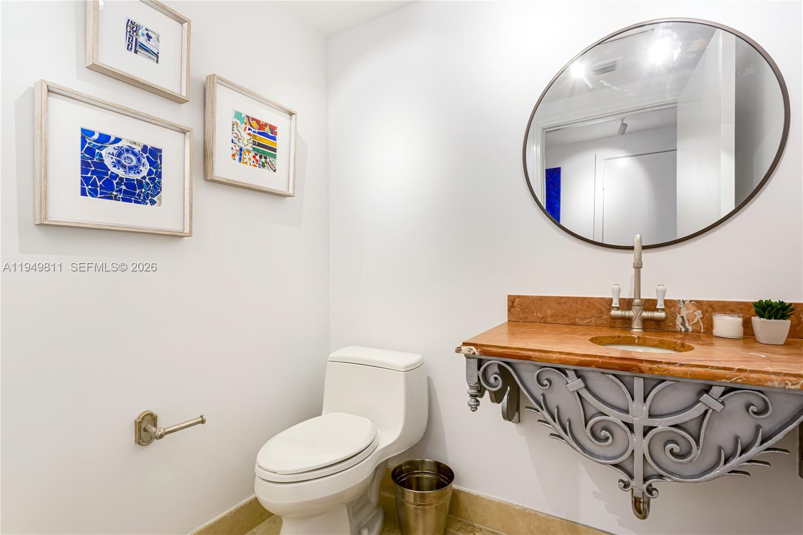 3400 Southwest 27th Avenue, Unit 2104 Miami, FL 33133 - Photo 4 of 26 a bathroom with a toilet a sink and mirror