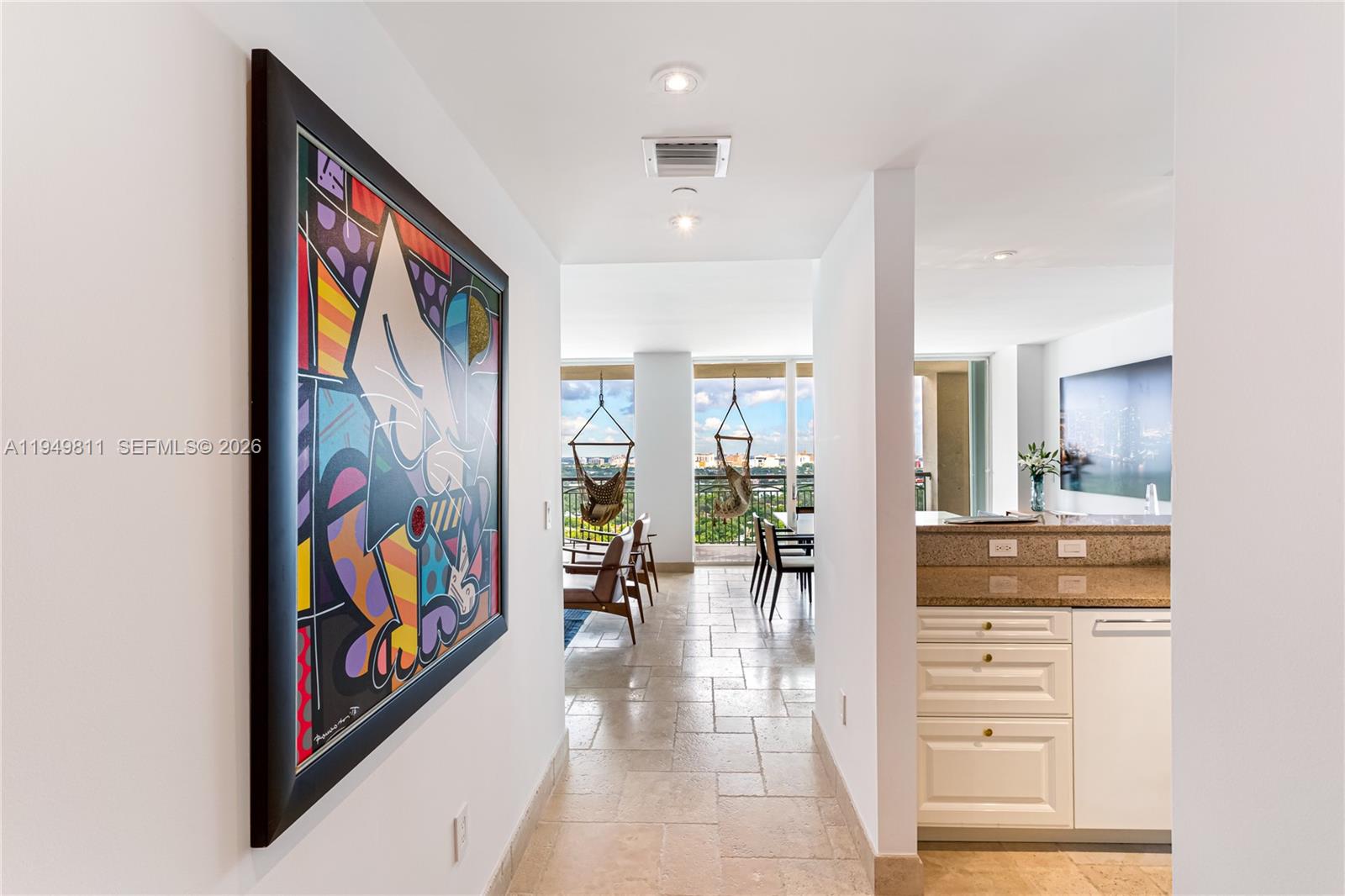 3400 Southwest 27th Avenue, Unit 2104 Miami, FL 33133 - Photo 5 of 26 a view of a hallway with furniture and breakfast area