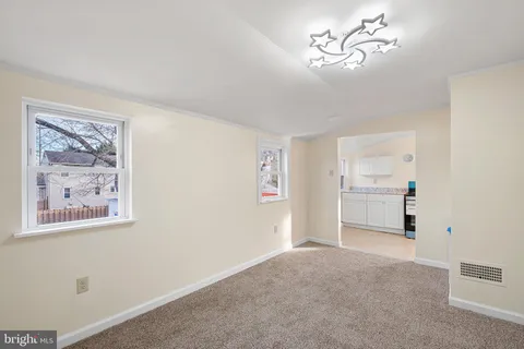 a view of a workspace with furniture and a chandelier fan