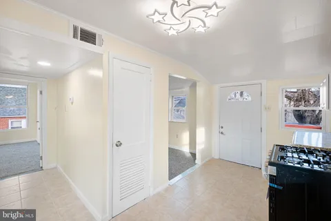 workspace with wooden floor closet and windows
