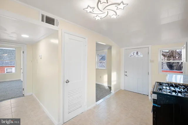 workspace with wooden floor closet and windows