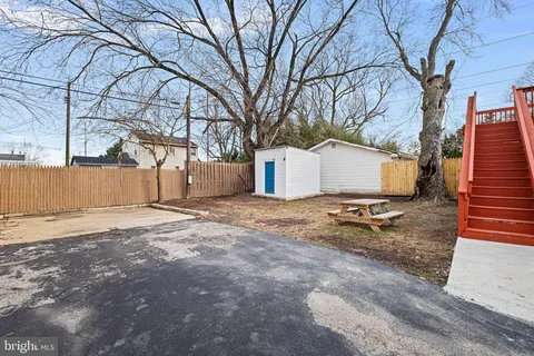 a view of a backyard with large trees