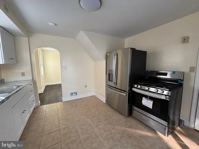 a kitchen with stainless steel appliances granite countertop a sink and stove