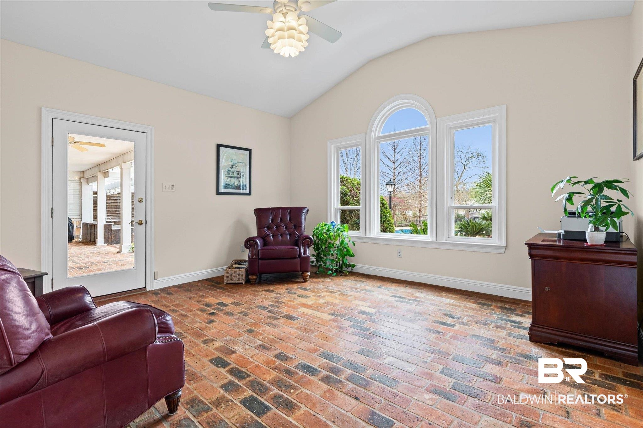4851 Audubon Drive Mobile, AL 36619 - Photo 12 of 46 Living area featuring plenty of natural light, brick floors, vaulted ceiling, and a ceiling fan