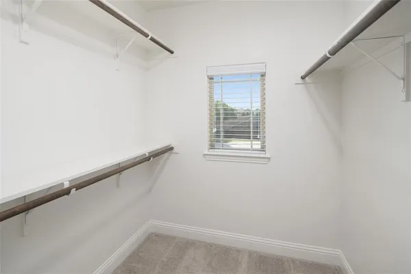 a view of small space with racks on the wall and a window