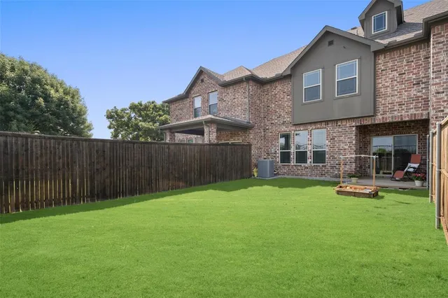 a view of a house with a yard and sitting area