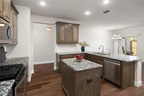 a kitchen with a sink stove and cabinets