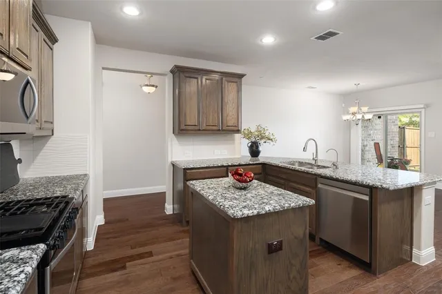 a kitchen with a sink stove and cabinets