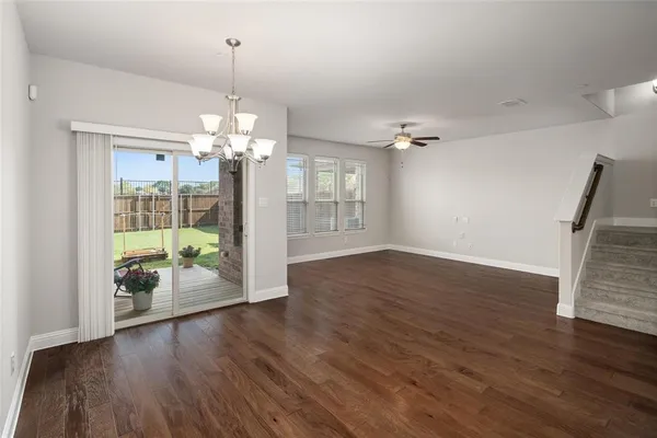 a view of a room with wooden floor and window