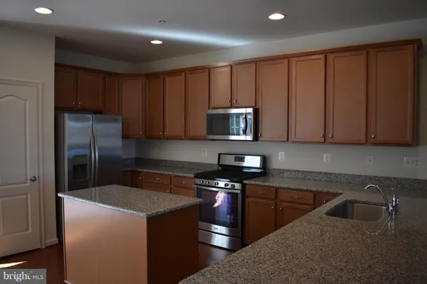 a kitchen with a sink a stove and refrigerator