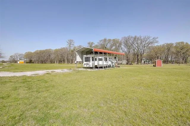 a view of a house with a yard patio and swimming pool