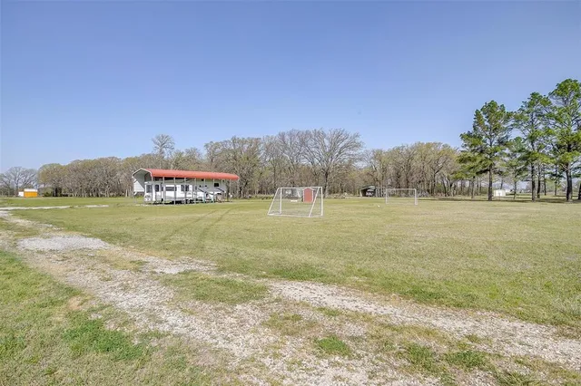 a spacious bedroom with a large bed and chandelier