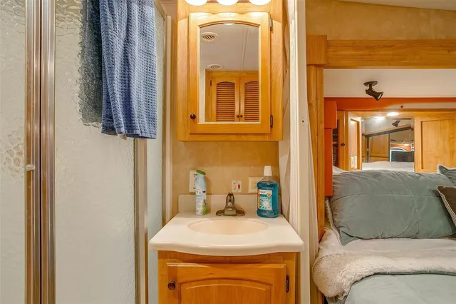 a bedroom with a large bed and a wooden floor