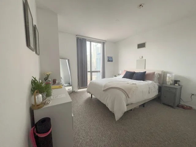 a bedroom with a bed and a potted plant
