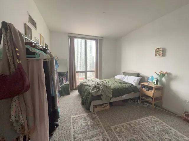 a bed sitting in a bedroom next to a window