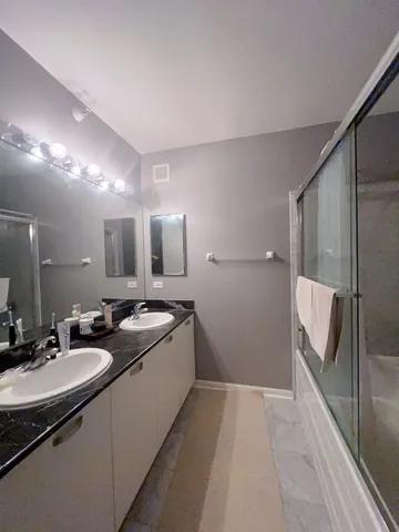 a bathroom with 2 sink and a mirror