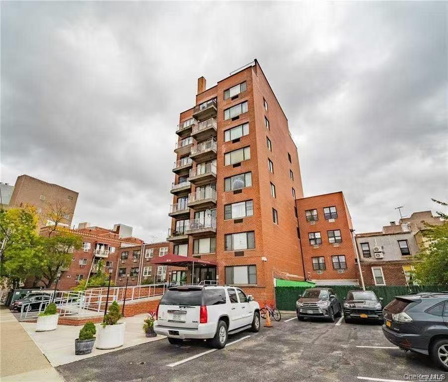 87-14 57th Road, Unit 3B Queens, NY 11373 - Photo 2 of 14 a city street filled with lots of traffic and cars