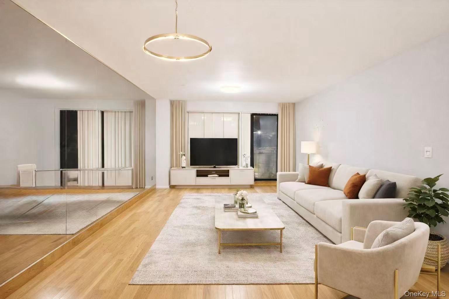 87-14 57th Road, Unit 3B Queens, NY 11373 - Photo 3 of 14 a living room with furniture and a flat screen tv
