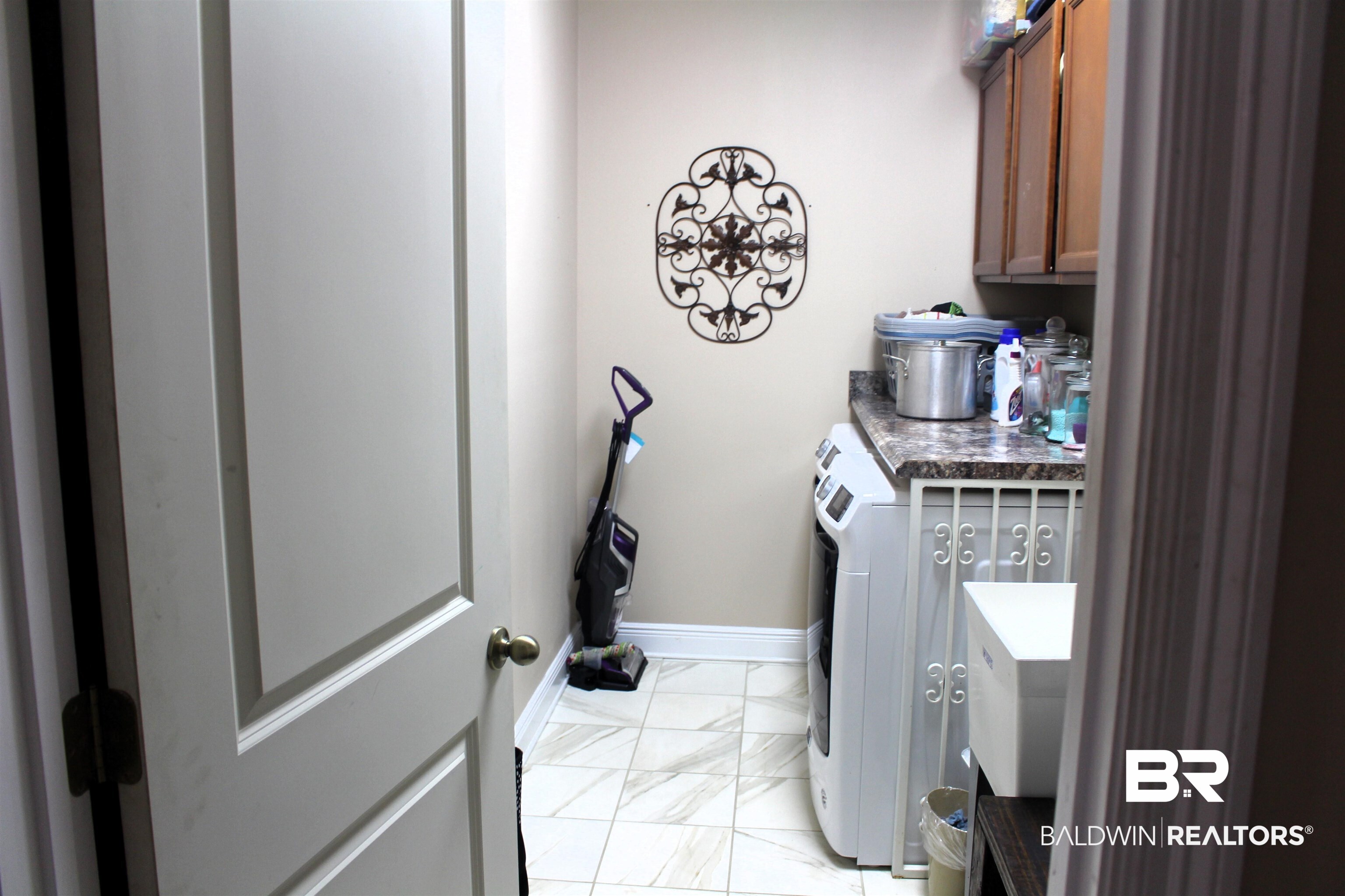 41416 Davis Duck Road Bay Minette, AL 36507 - Photo 63 of 72 Laundry area featuring independent washer and dryer, light tile patterned floors, and cabinets